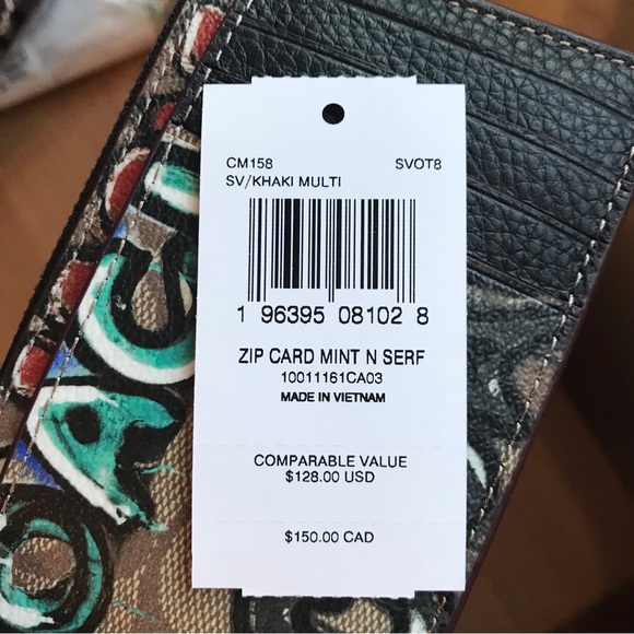 Signature coated canvas and refined pebble leather Five credit card slots Zip po - Picture 10 of 11